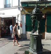 IN FRONT OF SHAKESPEARE AND COMPANY BOOKSTORE.