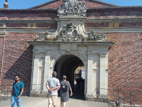 First one walks over the bridge that spans a moat and then one enters this gate to enter the courtyard of Kronborg castle.