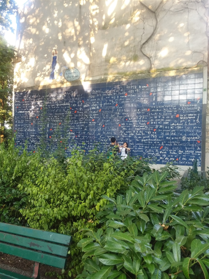 Here is the other photo of the Wall of love. It is in a small but lovely park with plants and benches for an ultimate time of relaxation. Le mur des Je t'aime is in Square Jehan Rictus in the Montmartre neighborhood of Paris. It was created by Fédéric Baron (a calligrapher) and Claire Kito (a mural artist). It has 612 tiles which are made of enameled lava. The phrase 