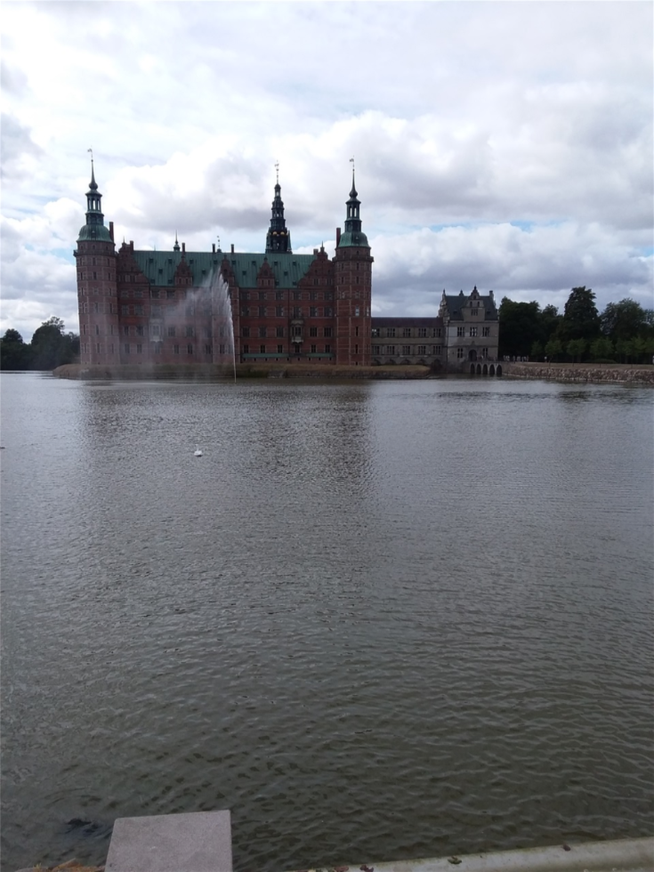 Within the town of Hellerød,  Danmark one will discover this beautiful castle. The grounds are so expansive that we spent 2 hours walking through the gardens and around the lake. This does not include the time inside the castle museum. This is Frederiksborg Slot. 