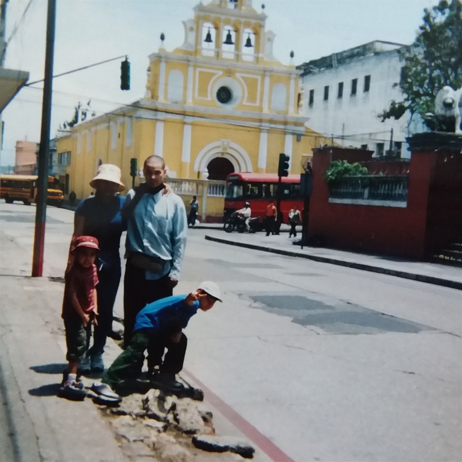 The first time my sister ever left USA was when I brought her to Guatemala. It is so inexpensive to travel to and live in Guatemala that I knew my sister could afford the trip. ANYBODY can afford Guatemala 😄😄😄. We visited Guatemala City, Antigua, Lake Atitlán, and Volcan Pacaya. She can not be seen in this photo because she is making this photo so I can be photographed with my family which is a rare event for us because I am almost always making the photos posted on my website...We booked our trip to the Pacaya volcano while we were staying in Antigua. Volcan de Fuego, Volcan Atenanchango, and Agua Volcano are also in the area of Antigua. This is a fairly small to medium sized city that was a Spanish colonial capital in southern Guatemala. It was the Spanish capital for about 200 years but an earthquake in 1773 destroyed much of Antigua and it lost its status as capital. Guatemala City is now the capital with its international airport that has flickering lights and electrical outages like a true third world or developing country. I am sure that improvements have been made since the year we were there. Antigua was founded in 1542 and has a lot of beautiful architecture, much of it built in a Baroque style. There are many cobblestone streets in Antigua and the city is much more cozy that the huge metropolis which is Guatemala City. We spent much more time in Antigua and at Lake Atitlan than in the capital city. I imagine that most tourists do the same. There is even a large ruins from around 1550 in the middle of Antigua. This is even a UNESCO Heritage site. Many of the buildings that were destroyed by earthquakes have been authentically restored and ruins of some buildings can still be seen throughout the town. Santo Domingo Del Cerro free open air sculpture park is in Antigua. It is especially dedicated to the art works of Efrain Recinos who is a celebrated sculptor of Guatemala. The Arch of Santa Catalina is an iconic landmark in Antigua which is also one of the most photographed landmarks in the town. Near the arch is a market place where many textiles of this region are sold. The textiles are obtained directly from those who craft them. Wooden masks and images along with bead works can also be bought at the market. The market is large and it is known as Nim Po't market. Antigua is so wonderful that many people from other countries have moved here (bringing up real estate prices but also improving infrastructure for everybody).