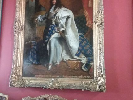 The Sun King Louis XIV. This painting is in the Louvre Museum. On the other hand, this king was NOT deposed by revolution. He died of old age. In this painting, he is wearing the robe that he wore for his coronation. He was king of France from 14 May 1643 until 5 September 1715. 5th of September is the day he passed away because of gangrene. He died at Versailles Palace because that is where he lived and held court. He was probably a good king for France. He did take his reign very seriously.  His monarchy was absolute throughout France. His foreign policy was very aggressive and his France was a truly great France. During his reign,  France was the dominant power in Europe. Art and other cultural aspects of French life became very important and much cultivated at this time. Thus, his long 72 year reign (one of the longest in the history of monarchies) can be considered as a golden age for France. He kept his court at Versailles which was like a den of opulence (a very large den to be sure). The nobility from around France would have to travel there to take care of business and spend a few days or weeks in a rather decadent life style. Any resolve that any nobles had to complain about or plot against the king would have been diminished this way. The sun King was also able to distance himself and his court some ways from the population of Paris.  Holding his court in Versailles, the center of government was in France,  not just Paris. I do not believe Versailles could have been considered a suburb of Paris as I think it is today.  Thus, his court represented the power of a strong France rather than a strong Paris. He said;