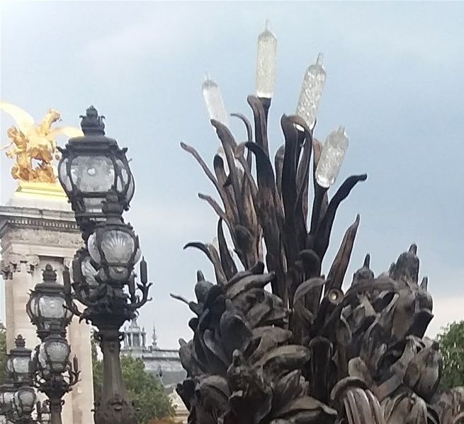 After we left Place de Concorde, I wanted to bring my family to Petit Palais but I led them south across the Seine River via Pont de la Concorde. We slowly walked along Quai d'Orsay and then came to Pont Alexander III. We VERY slowly crossed Pont Alexander III towards Grande Palais and Petit Palais. This is one photo taken while we walked across the bridge. The lamppost in the background is an example of several very unique lampposts in Paris. This lamppost was erected around 1900 so it probably has always been electric rather than converted to electric from gas.