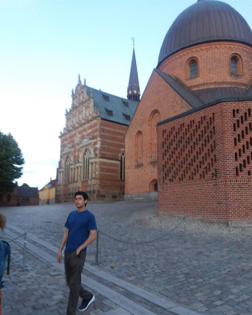 In front of the mausoleum of Roskilde Cathedral with the Yellow Palace (Royal Mansion) further down the very large square.