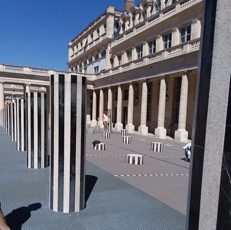 My page called Travel Photos has a couple of photos of the Domaine National du Palais-Royal. This photo has some of the famous stripe columns of Daniel Buren which are in the courtyard. There are about 260 columns of various heights. The Palace itself was constructed between 1633 and 1639. These columns were added to the courtyard in 1986.